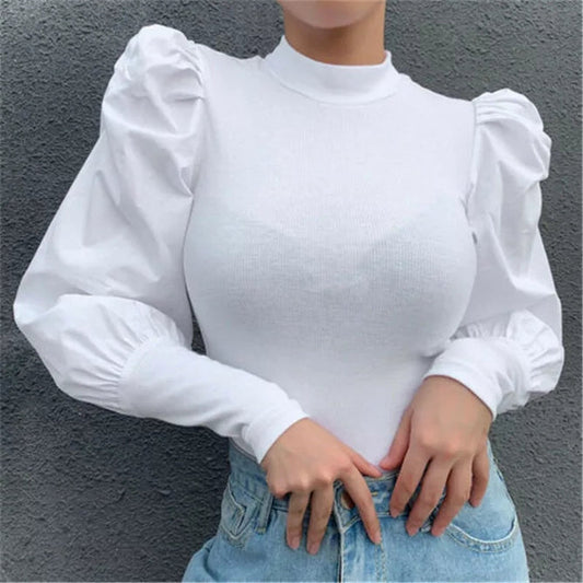 Assorted tops displayed, including t-shirts, blouses, sweaters, and tank tops in various colors and styles, suitable for casual or formal wear depending on the design