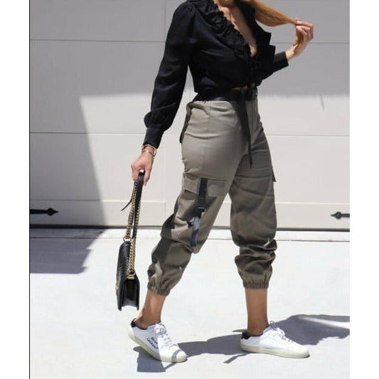 Cargo pants displayed in various colors and styles, featuring multiple pockets on the legs and a relaxed fit, suitable for outdoor activities or casual wear